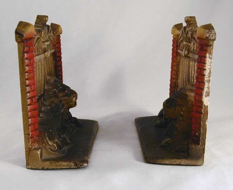 Antique Cast Iron Bookends Lion in Front of Metal Gate  